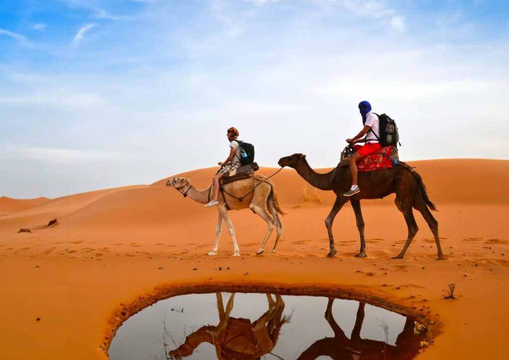 Turyści jadący na wielbłądach po pustyni Sahara w Maroku