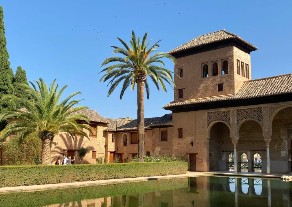 Alhambra w Granadzie – mauretański pałac i dziedziniec z palmami w Andaluzji na południu Hiszpanii