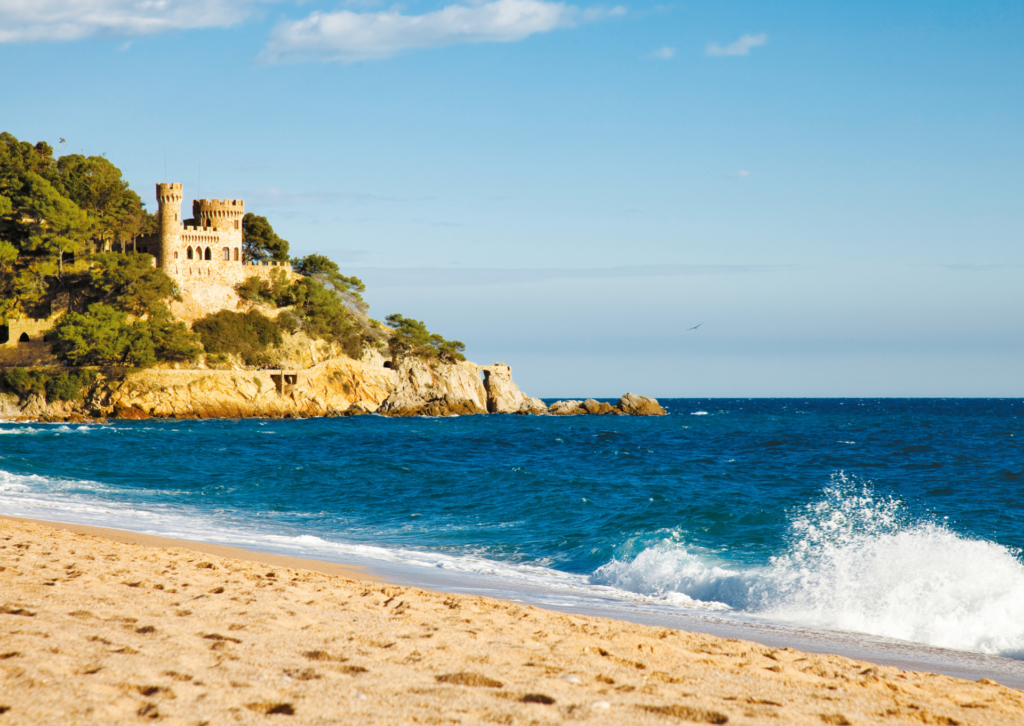 Malownicza zatoka Costa Brava z zamkiem na klifie i turkusową wodą