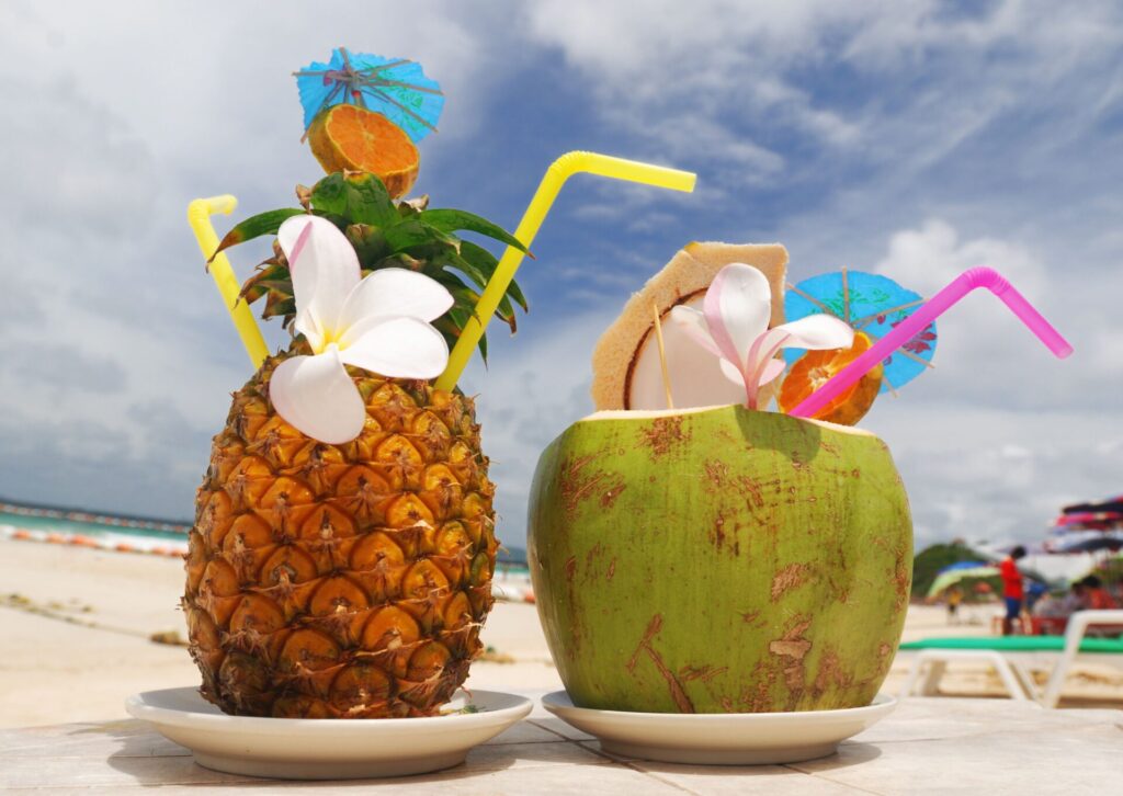 Egzotyczne drinki serwowane na plaży jako element oferty all inclusive co obejmuje